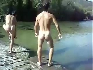 naked dudes jump in a river